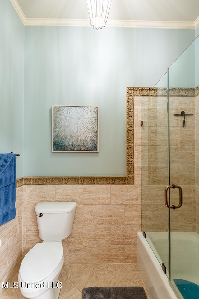 bathroom featuring tile walls, an enclosed shower, ornamental molding, and toilet