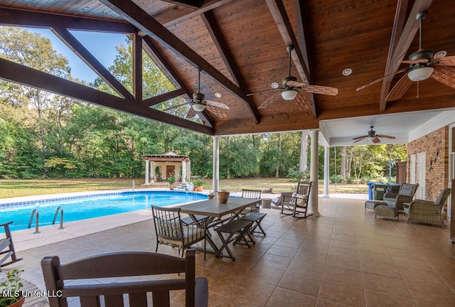 view of swimming pool featuring a patio area and ceiling fan