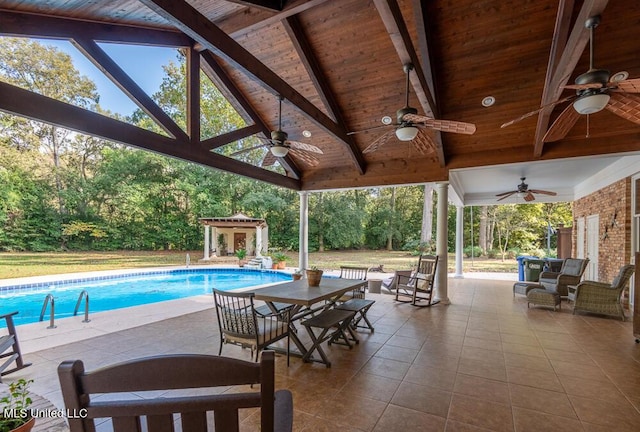 305 Creekbend Rd, Natchez, MS 39120 - outdoor pool featuring ceiling fan, a patio, view of wooded area, and an outbuilding