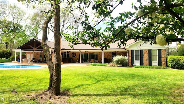 305 Creekbend Rd, Natchez, MS 39120 - back of property with a lawn, a patio, an outdoor pool, and brick siding