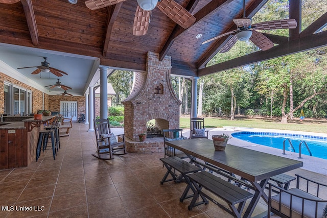 view of patio / terrace with an outdoor brick fireplace and ceiling fan