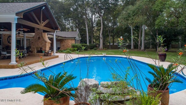 305 Creekbend Rd, Natchez, MS 39120 - swimming pool featuring a patio area, a ceiling fan, and view of scattered trees