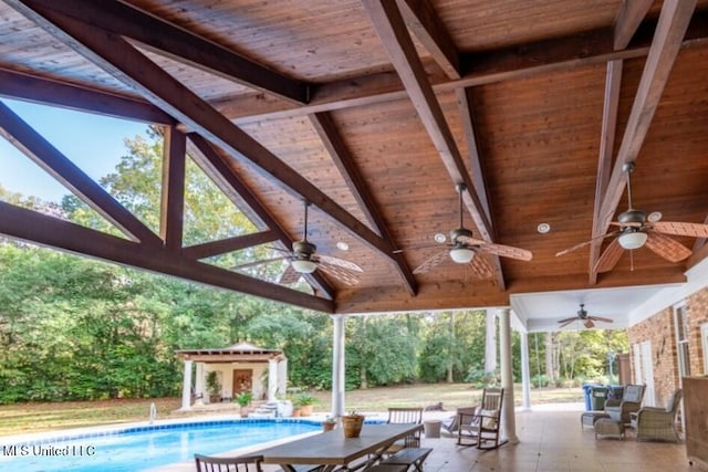 view of pool with a patio area, an outdoor structure, and ceiling fan