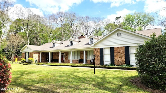 305 Creekbend Rd, Natchez, MS 39120 - cape cod home with brick siding, a front lawn, a porch, and a chimney
