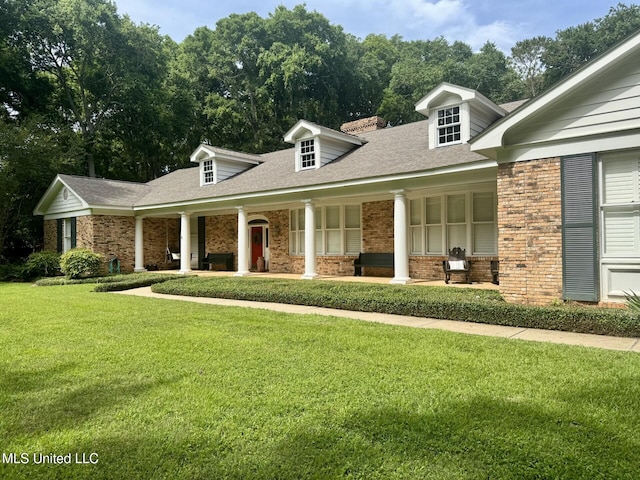 305 Creekbend Rd, Natchez, MS 39120 - new england style home with covered porch, brick siding, and a front yard