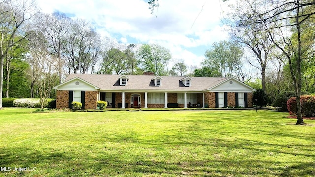 305 Creekbend Rd, Natchez, MS 39120 - view of front facade featuring a porch, brick siding, a front lawn, and a chimney