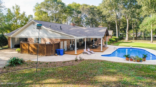 back of house featuring a patio and a lawn