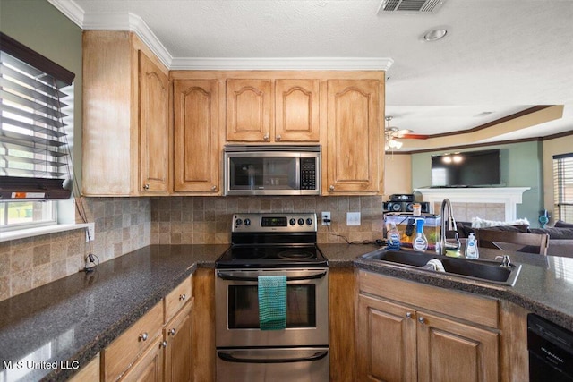 kitchen with stainless steel appliances, a sink, crown molding, decorative backsplash, and a ceiling fan