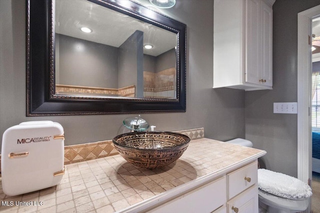 bathroom featuring vanity and toilet
