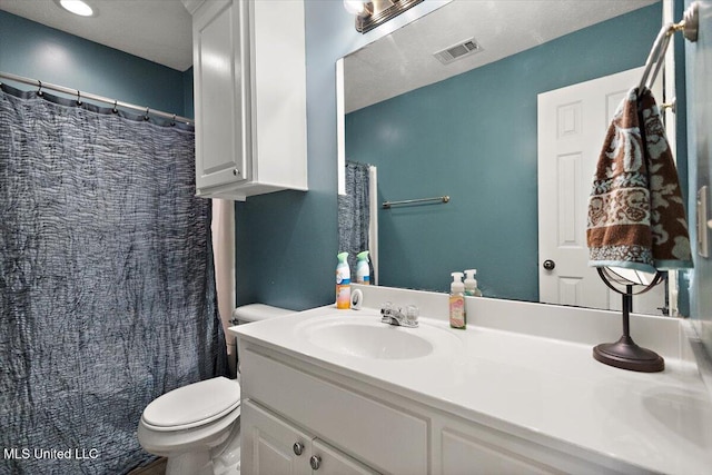 full bathroom featuring vanity and toilet