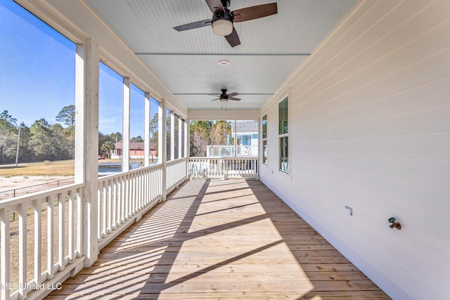 wooden deck featuring covered porch and ceiling fan