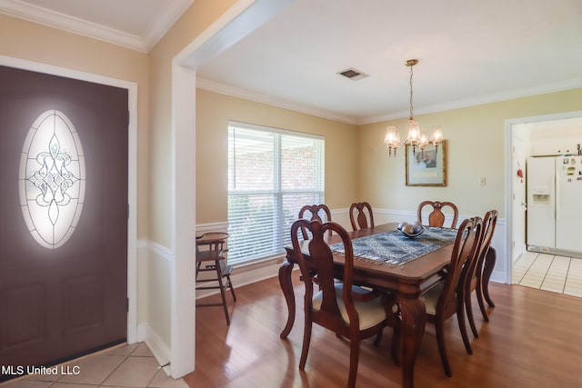 1 Partridge Pl, Long Beach, MS 39560 - dining space with a chandelier, light wood finished floors, ornamental molding, and baseboards