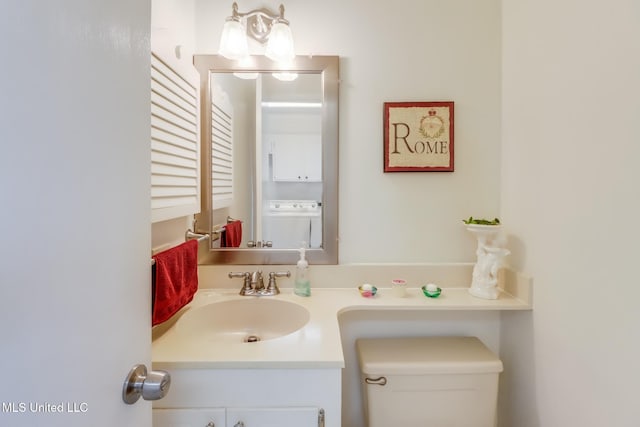 1 Partridge Pl, Long Beach, MS 39560 - bathroom with washer / clothes dryer, vanity, and toilet