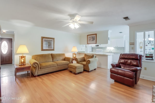1 Partridge Pl, Long Beach, MS 39560 - living area featuring light wood finished floors, ceiling fan, and ornamental molding