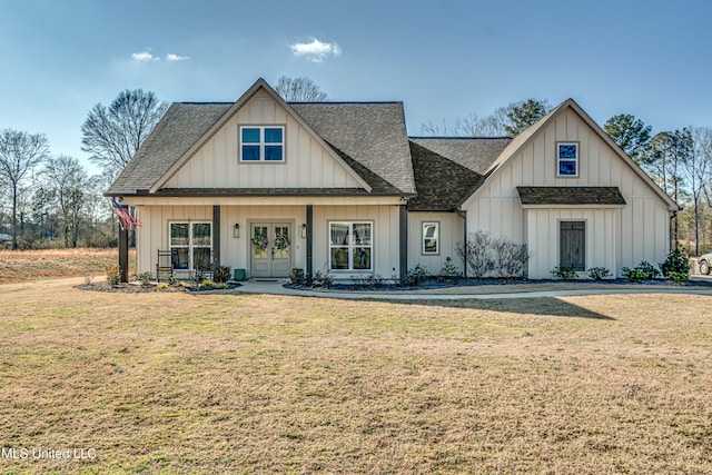 view of front of home with a front yard and french doors