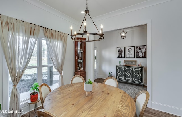 dining space with hardwood / wood-style floors and crown molding