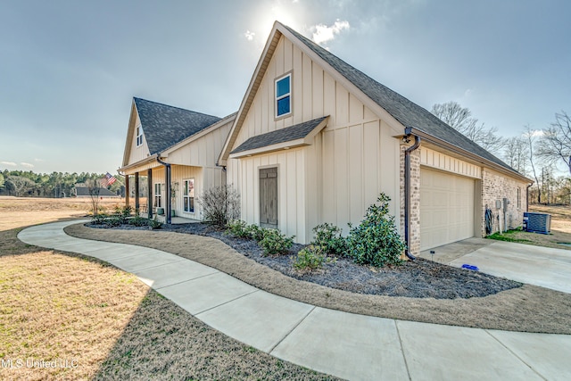 view of front of property featuring a garage and central air condition unit