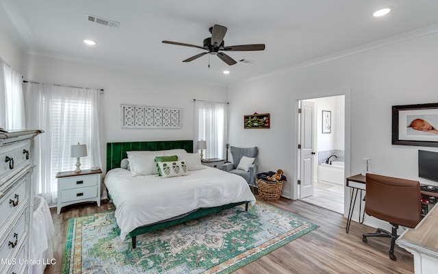 bedroom featuring ornamental molding, multiple windows, and light hardwood / wood-style flooring