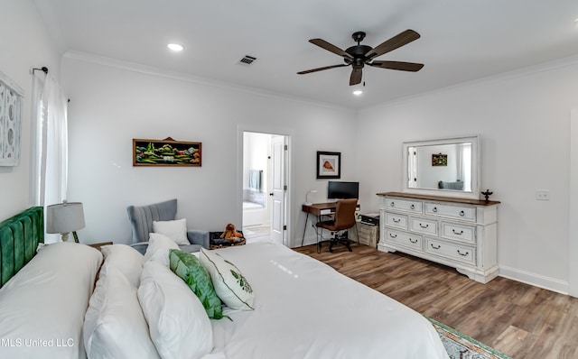 bedroom featuring hardwood / wood-style flooring, crown molding, connected bathroom, and ceiling fan