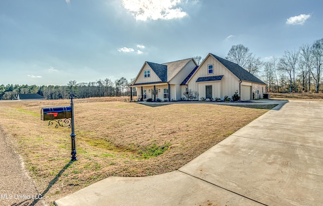 modern farmhouse featuring a garage and a front yard