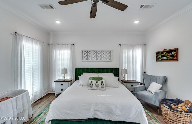 bedroom featuring ornamental molding, hardwood / wood-style floors, and ceiling fan