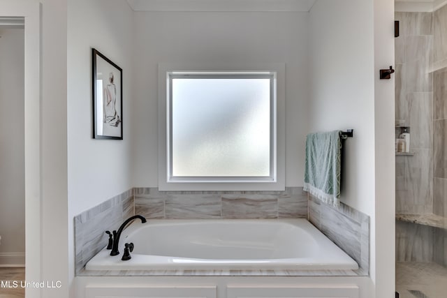 bathroom featuring shower with separate bathtub