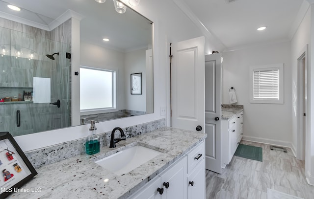 bathroom featuring vanity, crown molding, and a shower with door