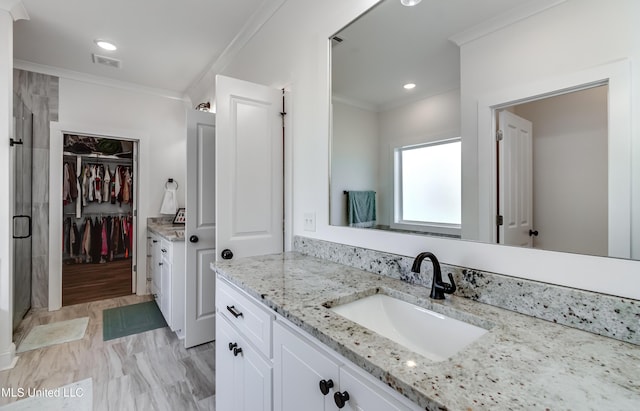 bathroom with ornamental molding and vanity