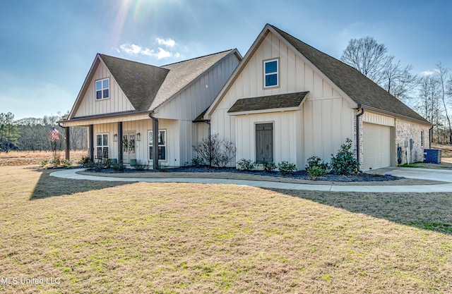 view of front facade with cooling unit, a garage, and a front yard