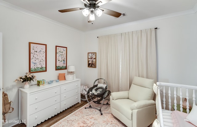 living area featuring hardwood / wood-style flooring, ceiling fan, and ornamental molding