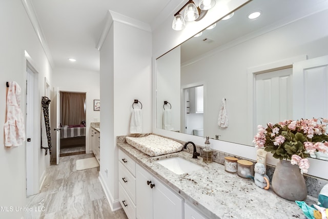 bathroom with ornamental molding and vanity