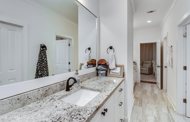 bathroom featuring ornamental molding and vanity