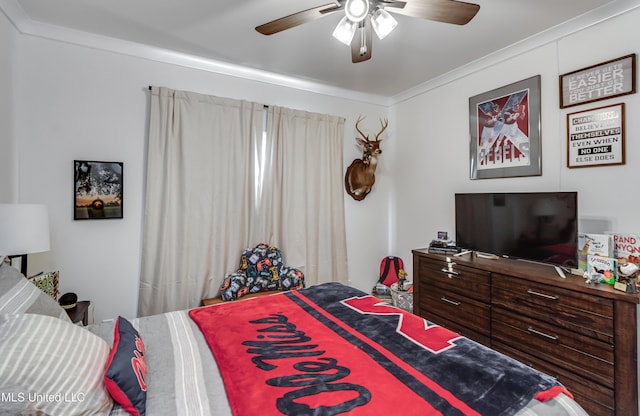 bedroom with ceiling fan and ornamental molding