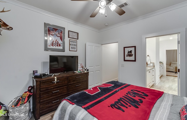 bedroom featuring crown molding, ceiling fan, and light wood-type flooring