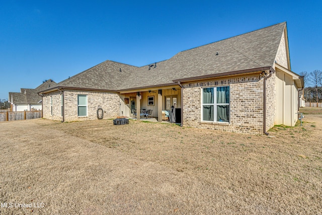 rear view of property with a yard