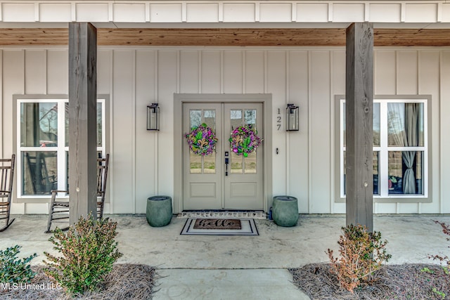 property entrance featuring french doors and covered porch