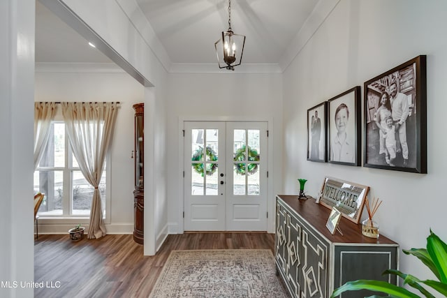 entrance foyer with crown molding, dark wood-type flooring, and french doors