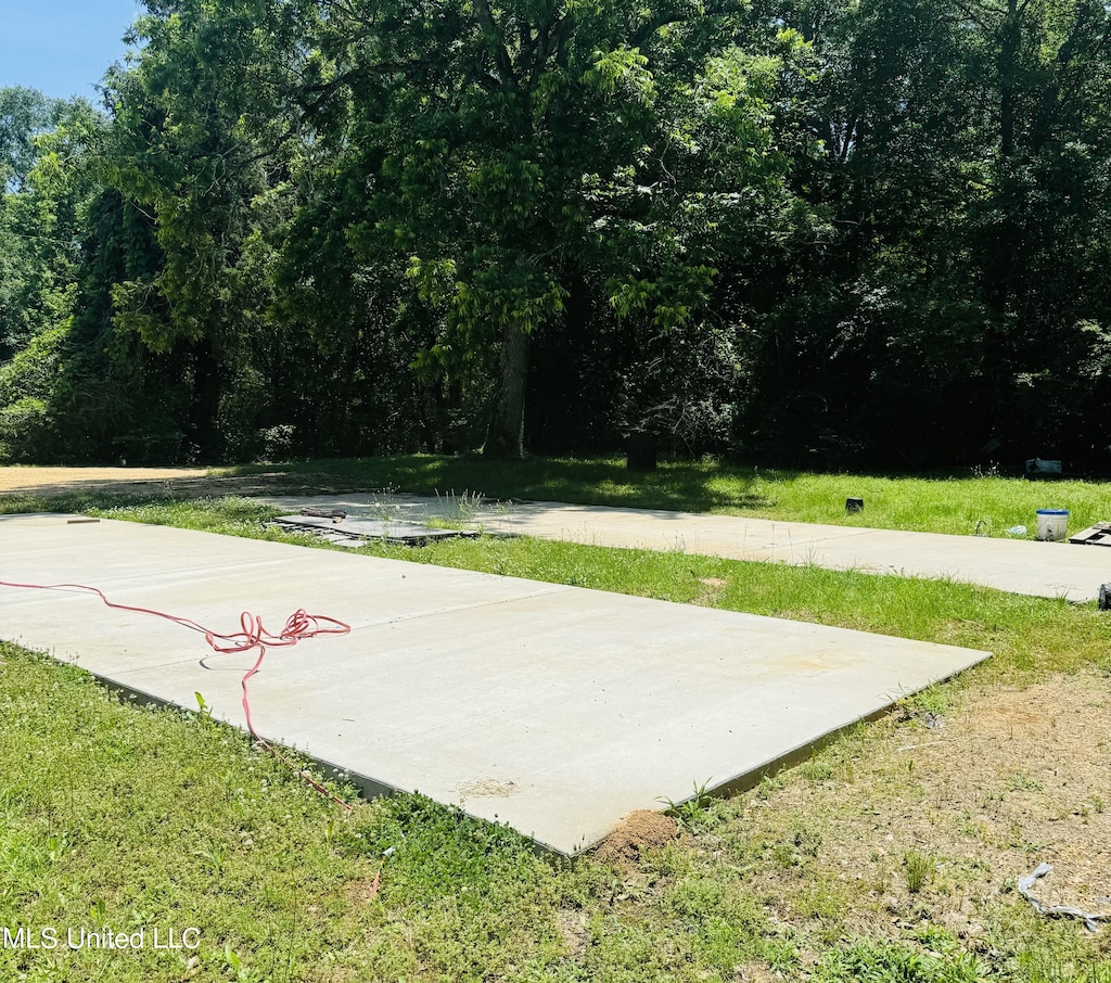 view of basketball court with a yard