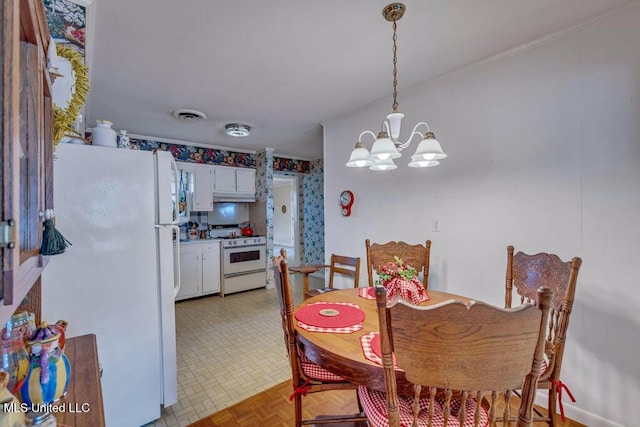 dining room with light parquet flooring and a notable chandelier