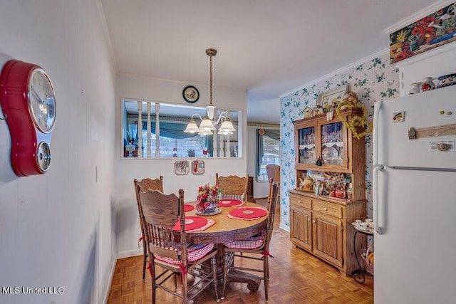 dining space featuring light parquet floors and a chandelier