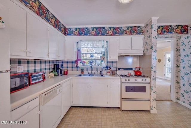 kitchen featuring a wealth of natural light, sink, white cabinets, and white appliances