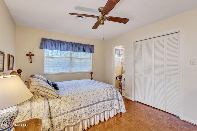 bedroom featuring ceiling fan, a closet, and parquet floors