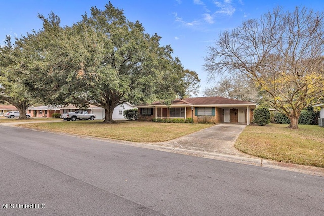 ranch-style house featuring a front yard and a carport