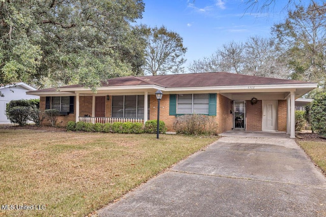 single story home with a carport, covered porch, and a front yard