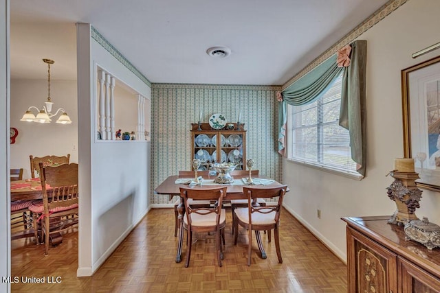 dining room featuring light parquet flooring and an inviting chandelier