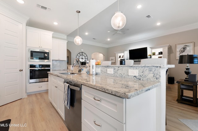 16872 W Landon Green Cir, Gulfport, MS 39503 - kitchen with appliances with stainless steel finishes, a sink, arched walkways, a ceiling fan, and ornamental molding