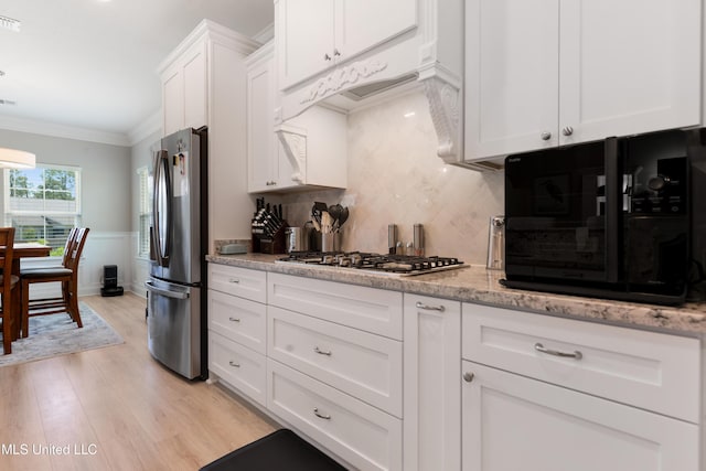 16872 W Landon Green Cir, Gulfport, MS 39503 - kitchen featuring stainless steel appliances, light wood-style floors, white cabinetry, tasteful backsplash, and ornamental molding