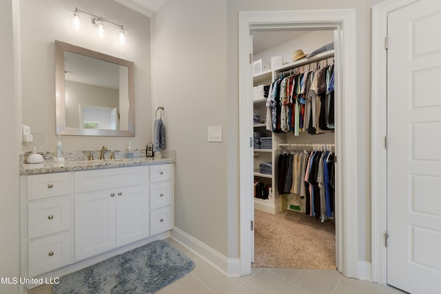16872 W Landon Green Cir, Gulfport, MS 39503 - bathroom featuring vanity, tile patterned flooring, a spacious closet, and rail lighting