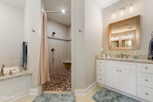 16872 W Landon Green Cir, Gulfport, MS 39503 - bathroom featuring a tile shower, a bath, vanity, tile patterned flooring, and baseboards