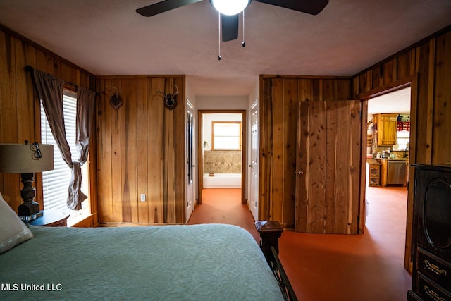 bedroom featuring wood walls, connected bathroom, and ceiling fan